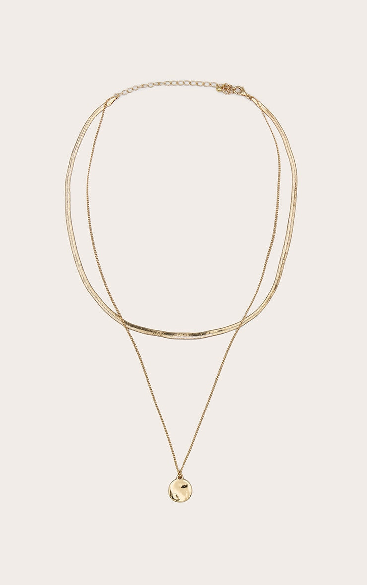 https://cdn-img.prettylittlething.com/1/7/d/1/17d149311f300f90a605630a90d79b2376c6f695_CNM0656_2_gold_circle_pendant_layered_snake_chain_necklace.jpg