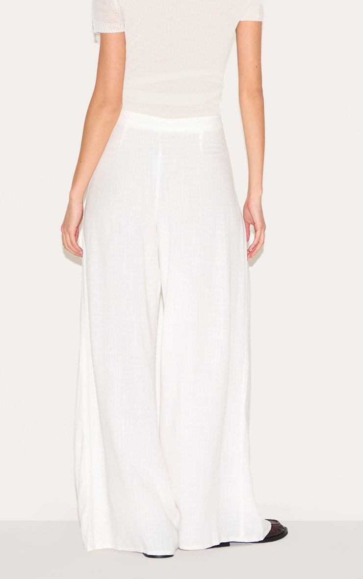 https://cdn-img.prettylittlething.com/1/d/c/e/1dce81b5db983ced2f1ad041e0879ea01609173a_CNM4243_3_white_linen_blend_floaty_pin_tuck_wide_leg_trousers.jpg