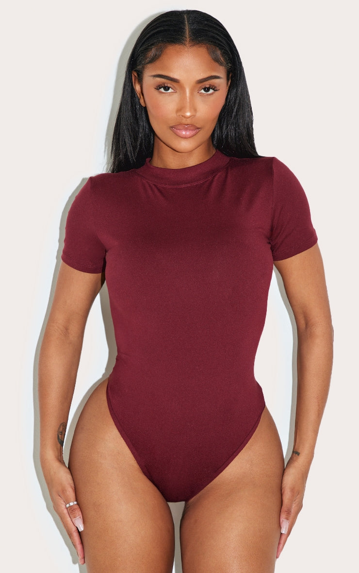 https://cdn-img.prettylittlething.com/2/1/4/a/214ab7082ea136cb32c552d7a79794118471cac0_CNL9499_2_shape_burgundy_sculpted_short_sleeve_bodysuit.jpg