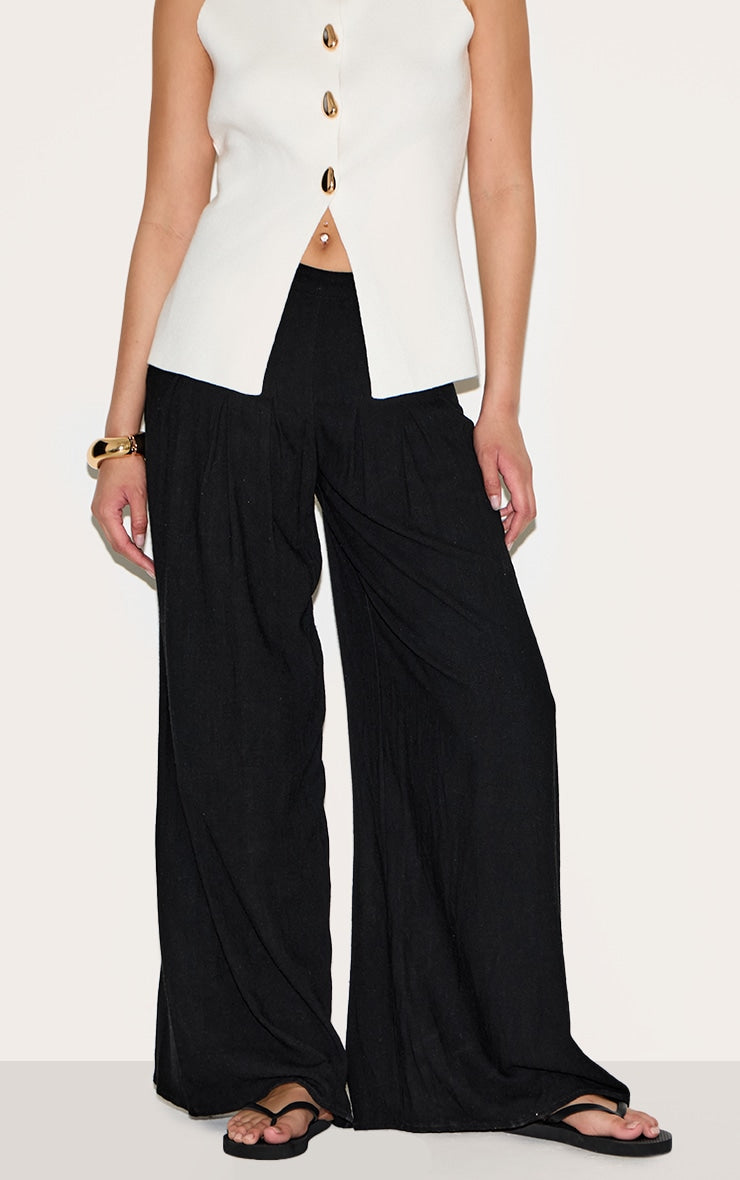 https://cdn-img.prettylittlething.com/3/4/3/d/343d264d4dd8afec6f329ea730c276689f4c7cbe_CNM4242_2_black_linen_blend_floaty_pin_tuck_wide_leg_trousers.jpg