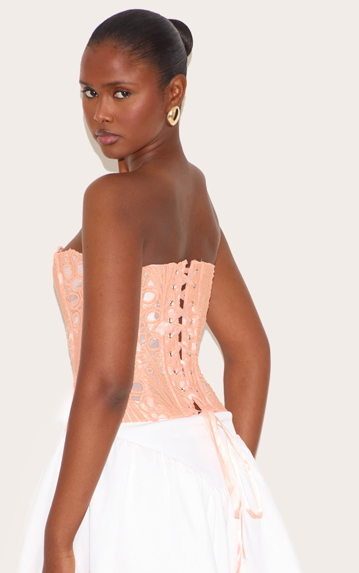 https://cdn-img.prettylittlething.com/3/8/b/5/38b5a54ce3007bf335f36cd566690d028d2c183d_CNM2901_2_peach_textured_sheer_floral_lace_corset.jpg