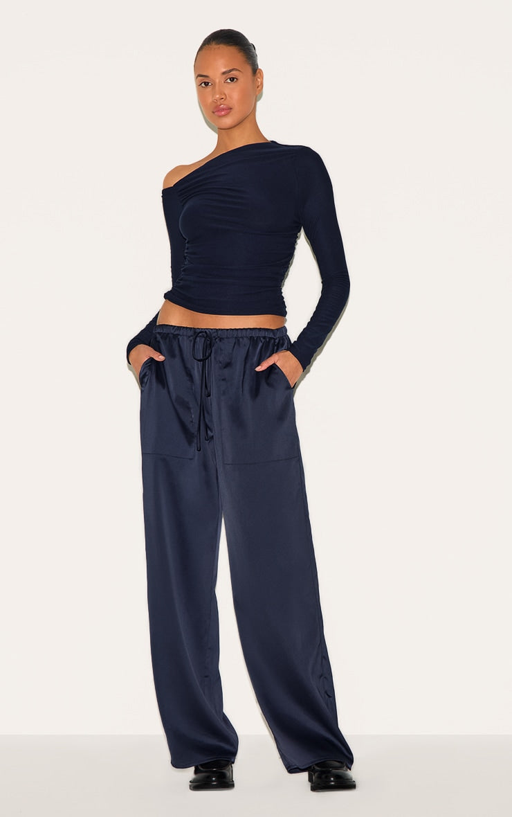https://cdn-img.prettylittlething.com/3/9/5/1/3951481ae3b4634119e220c457421c2e636fdaae_CNM6312_4_navy_soft_touch_asymmetric_detail_long_sleeve_top.jpg