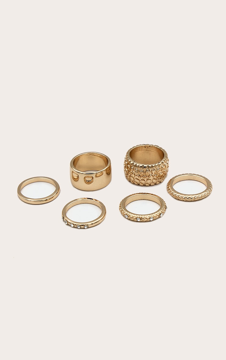 https://cdn-img.prettylittlething.com/4/4/8/4/44846a4c6e9ba26d528931fa41353a3cbf329acb_CNK9312_1_gold_jewel_texture_chunky_multipack_rings.jpg