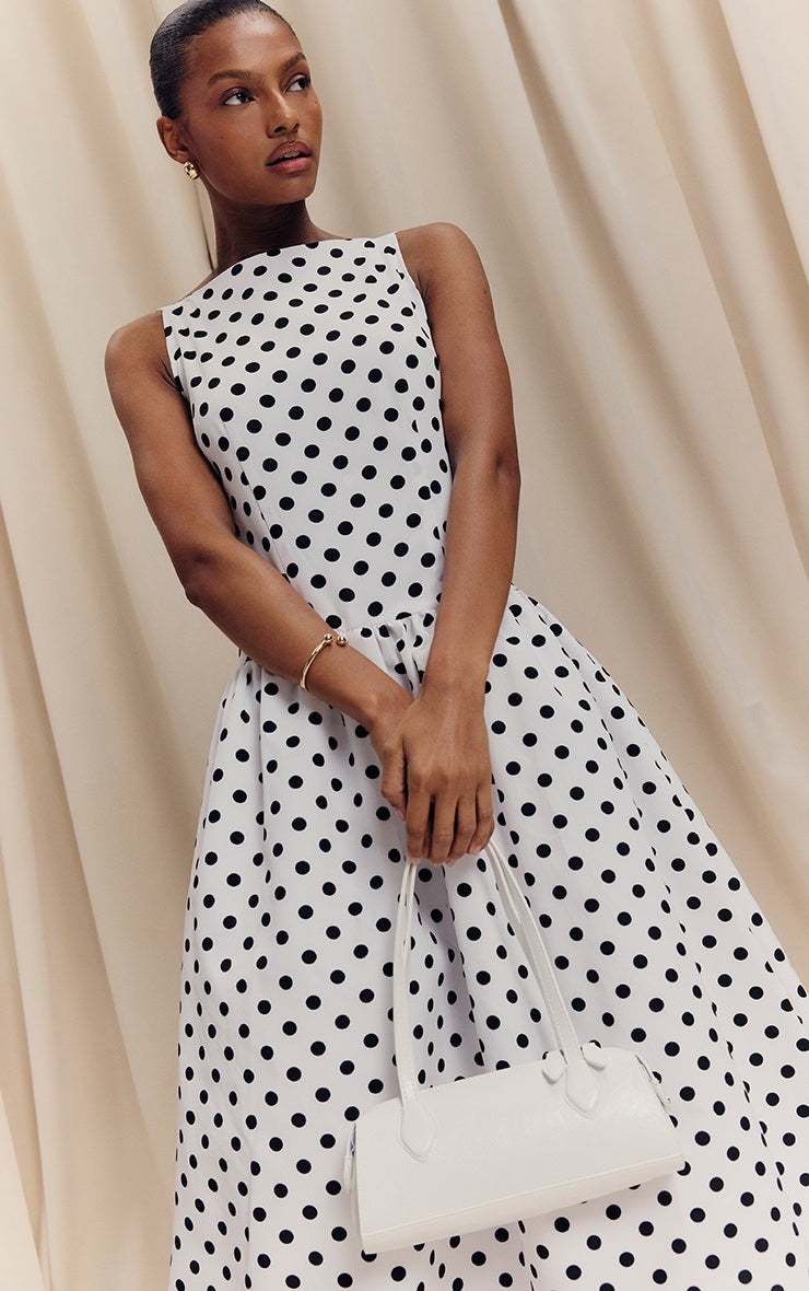 https://cdn-img.prettylittlething.com/5/1/9/a/519a8279c8fa145355bc0e7175aa0b84c1e0e801_CNL8368_1_monochrome_polka_dot_printed_dropped_waist_midaxi_dress.jpg