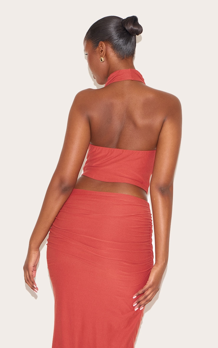 https://cdn-img.prettylittlething.com/8/a/4/a/8a4af77df15a666c128413ace4d190a68b87a56b_CNN0617_2_rust_soft_touch_ruched_halter_crop_top.jpg