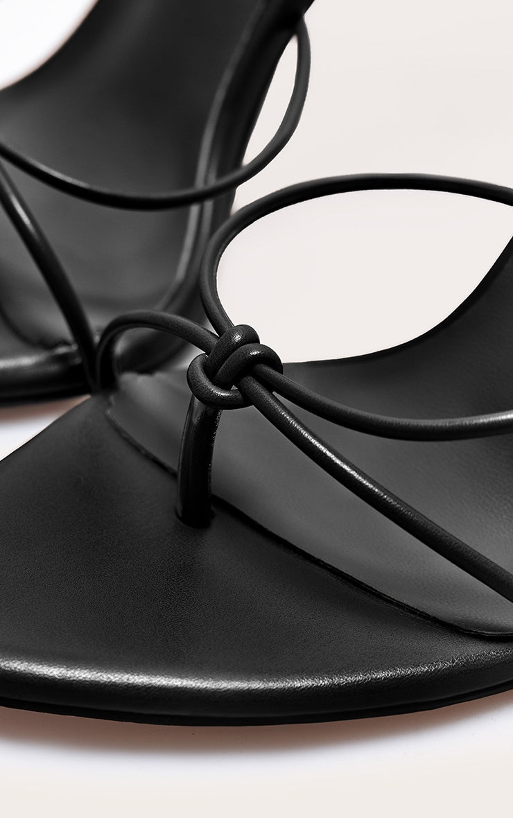 https://cdn-img.prettylittlething.com/9/e/f/7/9ef7a4069222b2ad5547e76b35fcbca54573b5ba_CNL8253_4_plt_label_black_strappy_tie_thong_heel.jpg