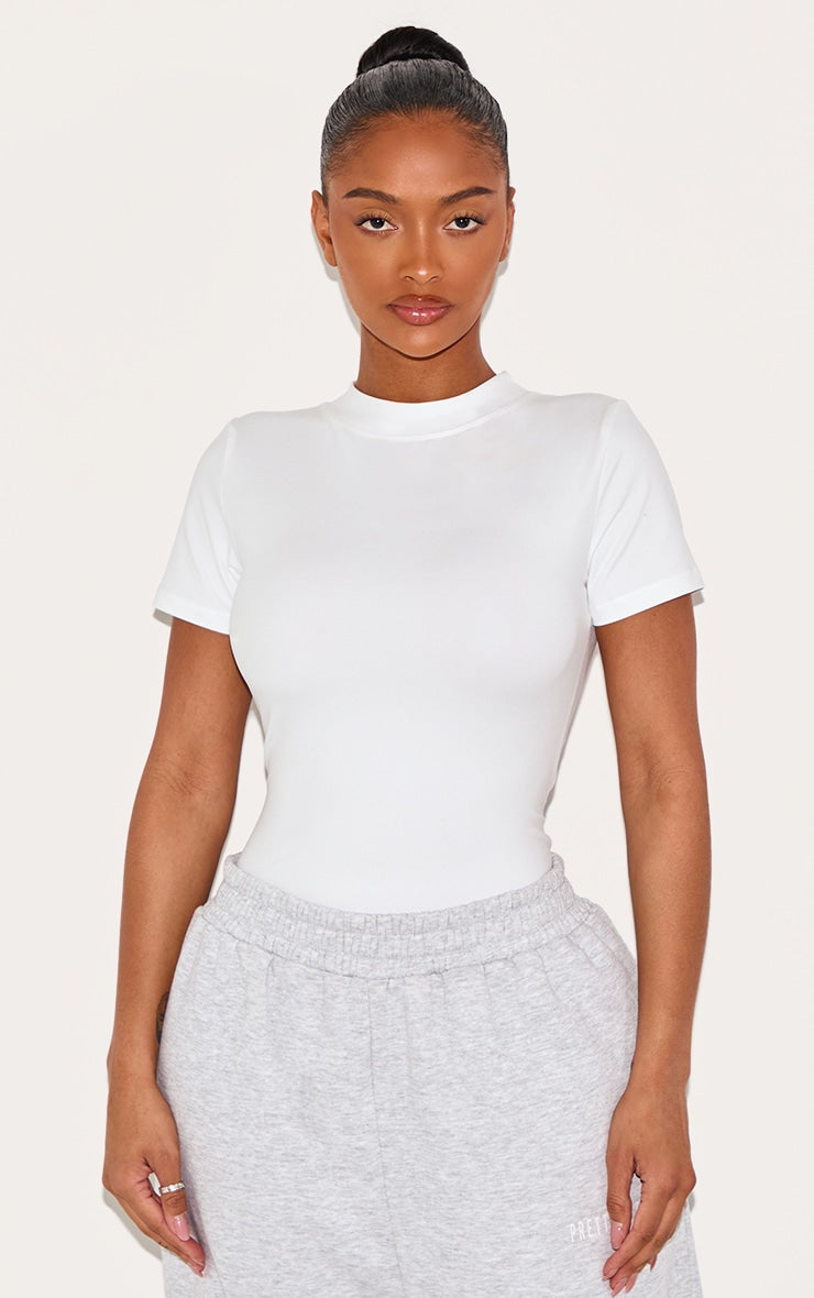 https://cdn-img.prettylittlething.com/a/7/0/e/a70e6c4590276b88ca77a7a5ff8b81c79b4e98c4_CNJ7652_1_shape_white_sculpted_short_sleeve_bodysuit.jpg