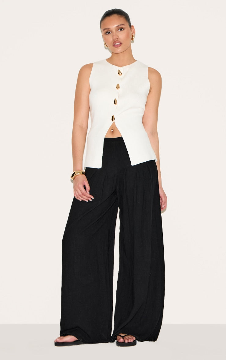 https://cdn-img.prettylittlething.com/d/1/a/a/d1aafbdbd146d70ce894650e95ce49f20e3dd489_CNM4242_1_black_linen_blend_floaty_pin_tuck_wide_leg_trousers.jpg