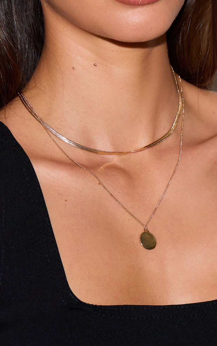 https://cdn-img.prettylittlething.com/e/3/9/e/e39ecff514955dda3515df7434cbed25b9994809_CNM0656_3_gold_circle_pendant_layered_snake_chain_necklace.jpg